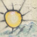 Graffiti of the sun shining on a hillside